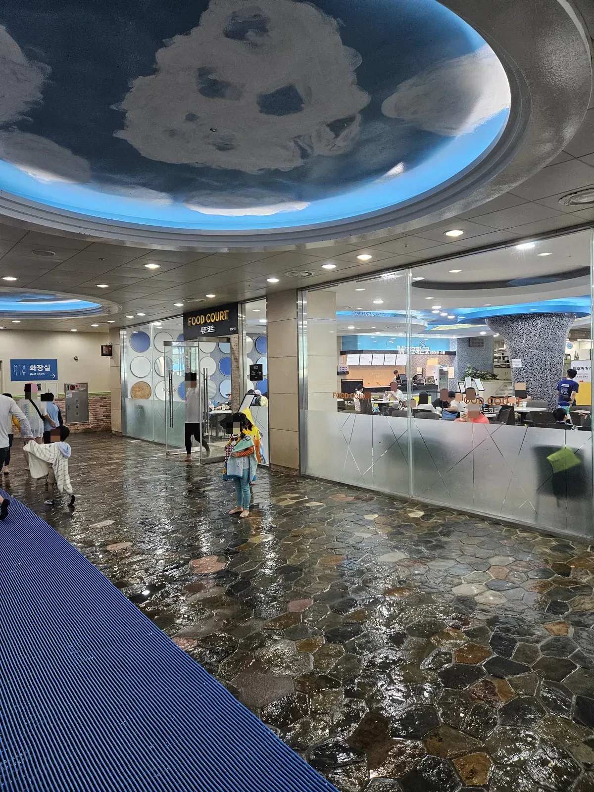 Cloud-painted ceilings over the food court and the walk-through to the restrooms