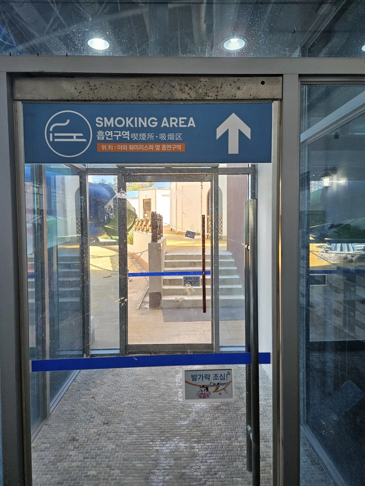 Head out through this door — the smoking area is just outside, on the right