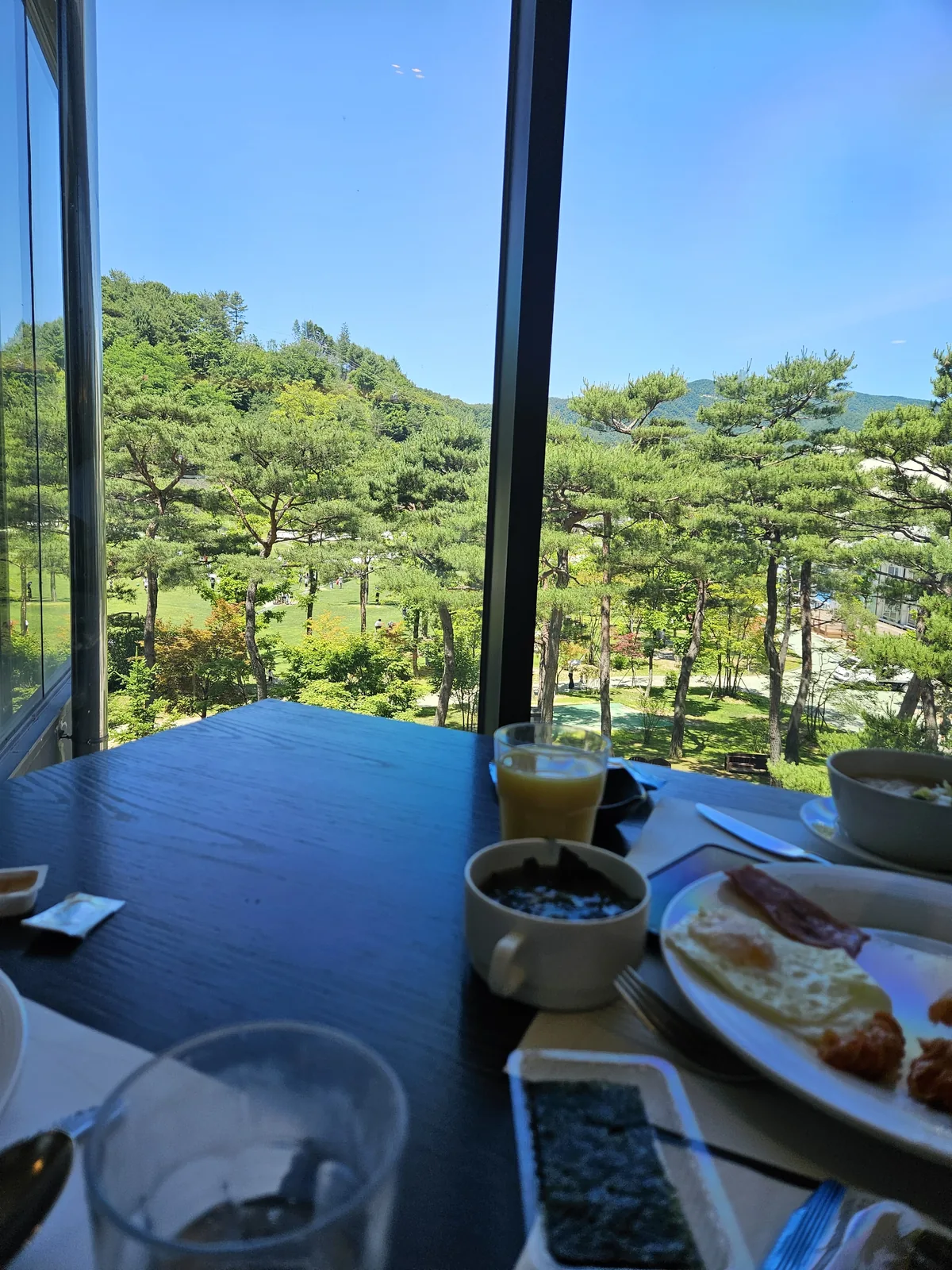 A window table at Ondo — fried egg, bacon, soup, and that garden view