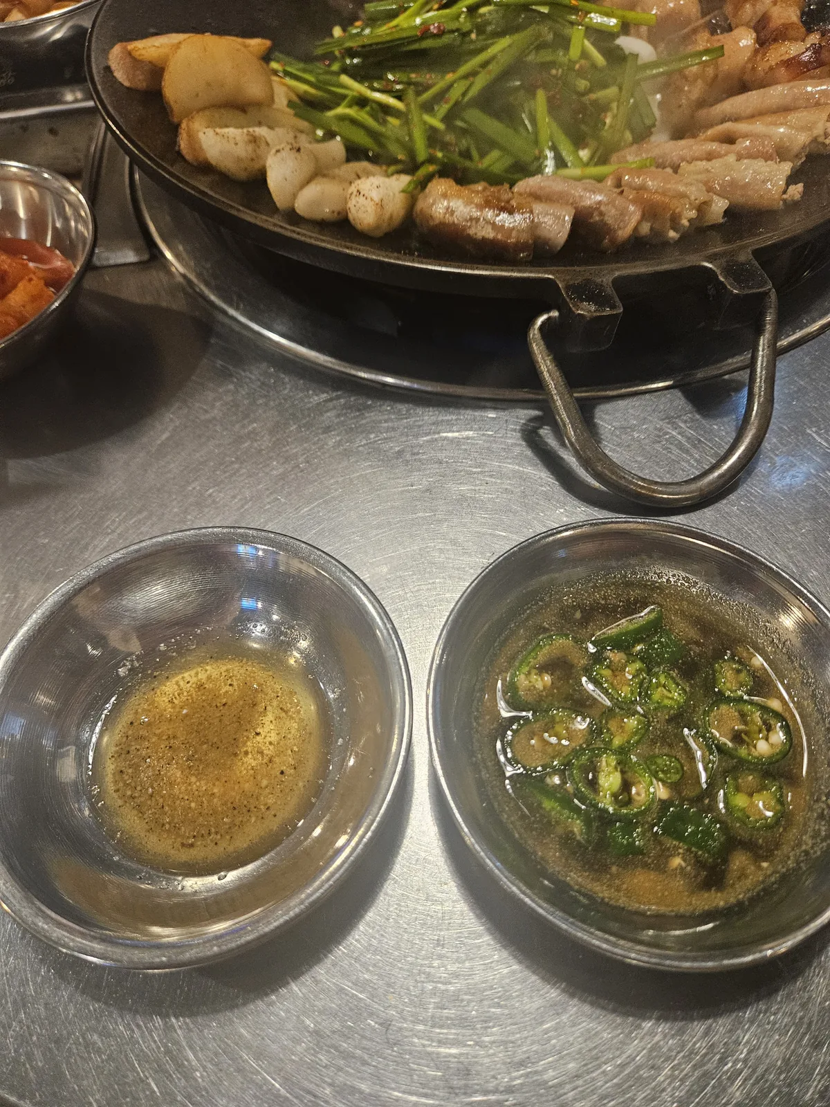 Two sauces — salt-and-sesame-oil on the left, soy-based on the right