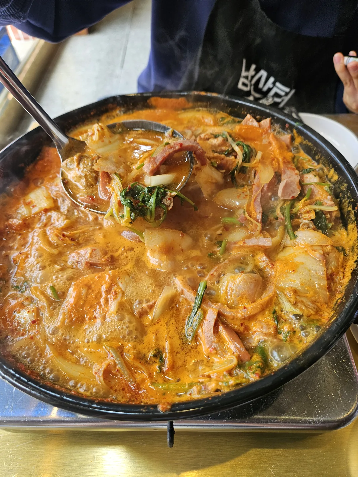 The bacon budae jjigae at Namsanter, bubbling at the table