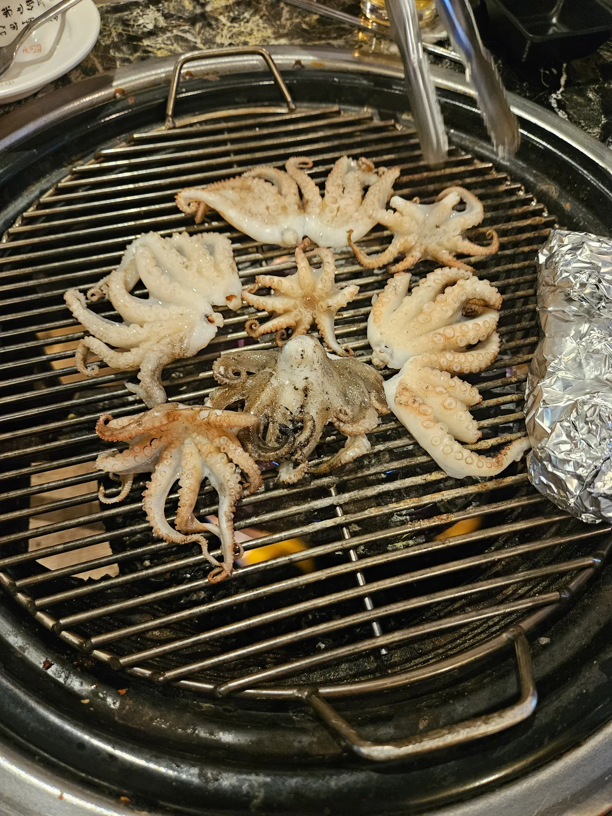 Roe-filled webfoot octopus over charcoal at Yajupocha